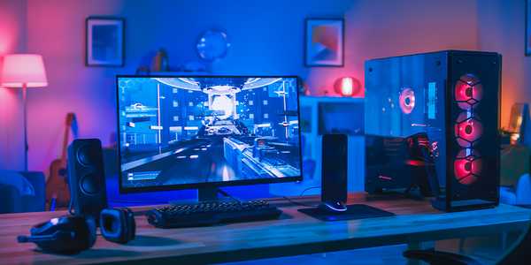 A Gaming PC set up with monitor, PC and RGB lighting.